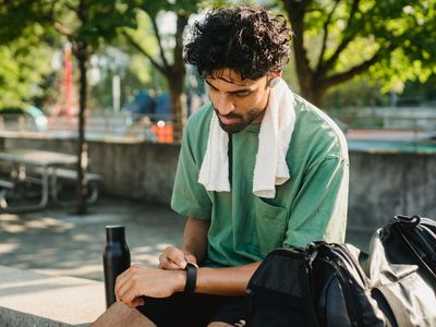 Bottle of water and a white towel on bench